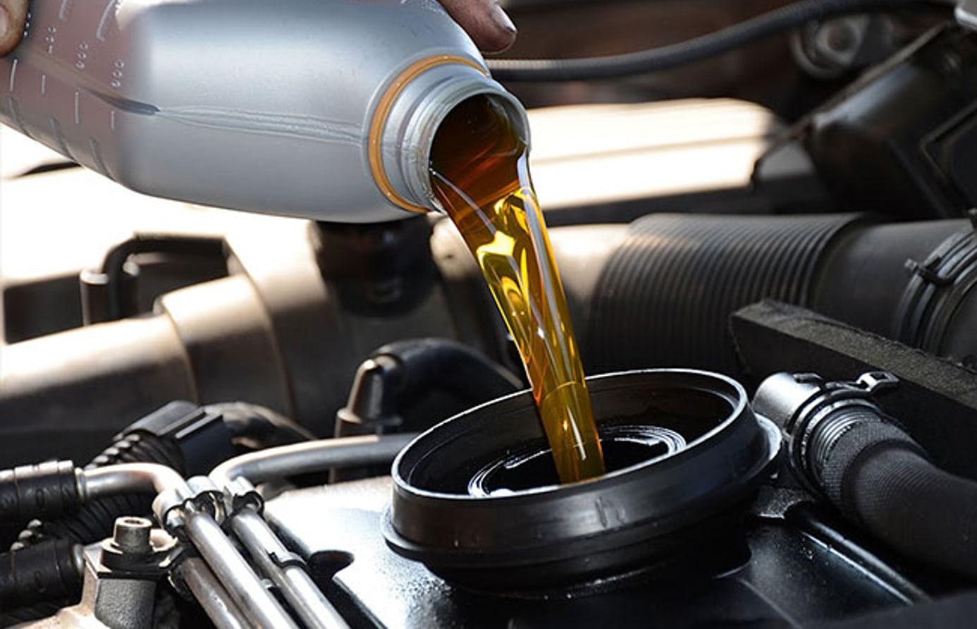 Engine oil being poured into a car engine