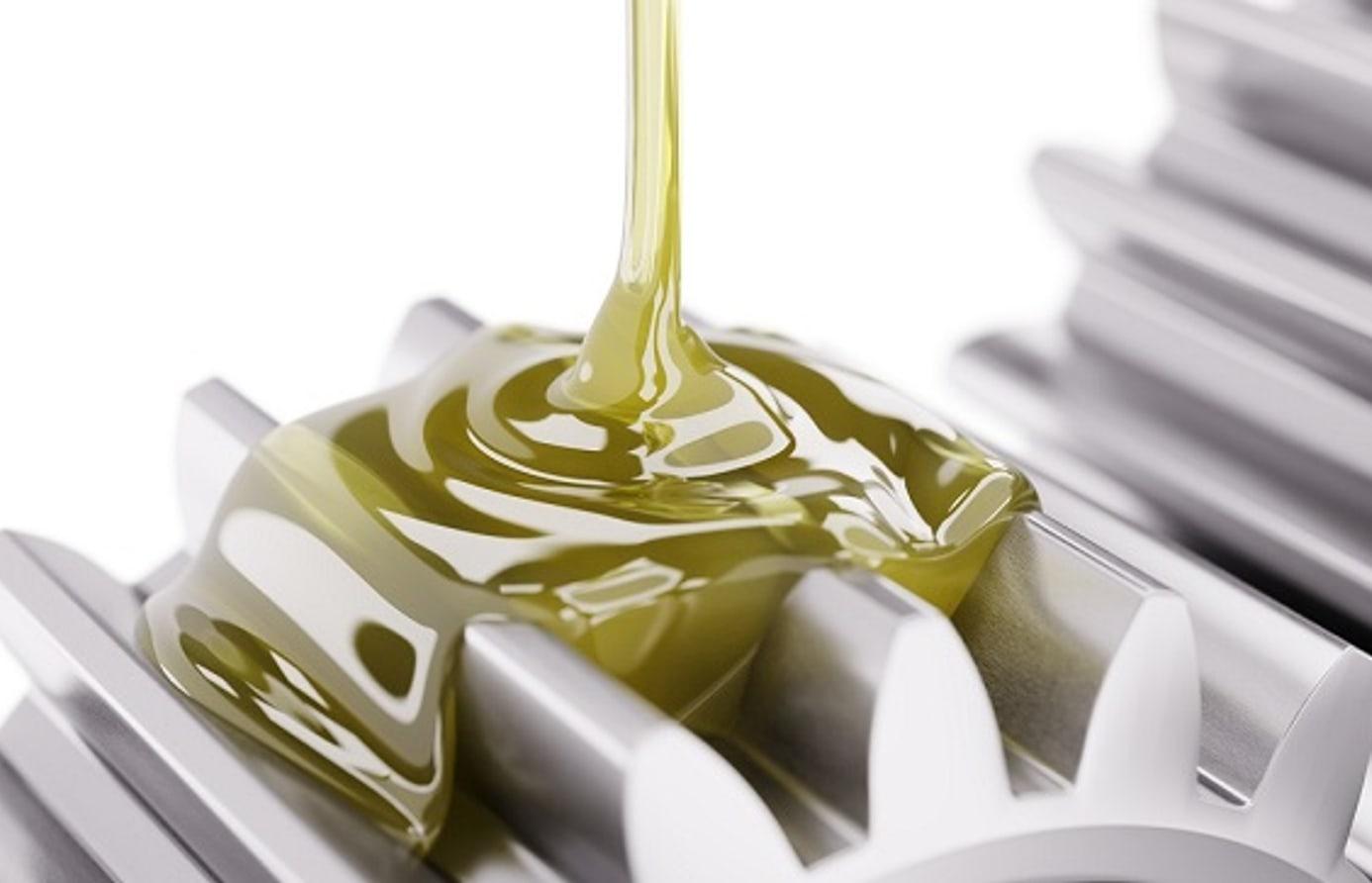 Lubricating oil flowing over machined metal gears
